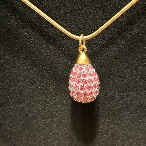 Pink and clear rhinestone oval sparkly necklace on gold tone chain.